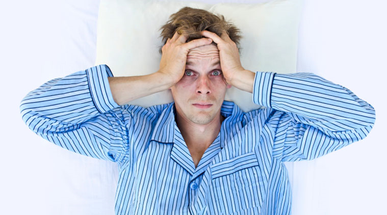 Anxiety causing man to lose sleep.